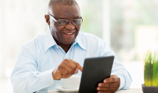 An African American man reading something on a tablet